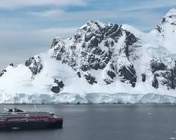 A scenic cruise ship sailing through icebergs highlighting the Chelsea Handler current boyfriend Antarctica date destination