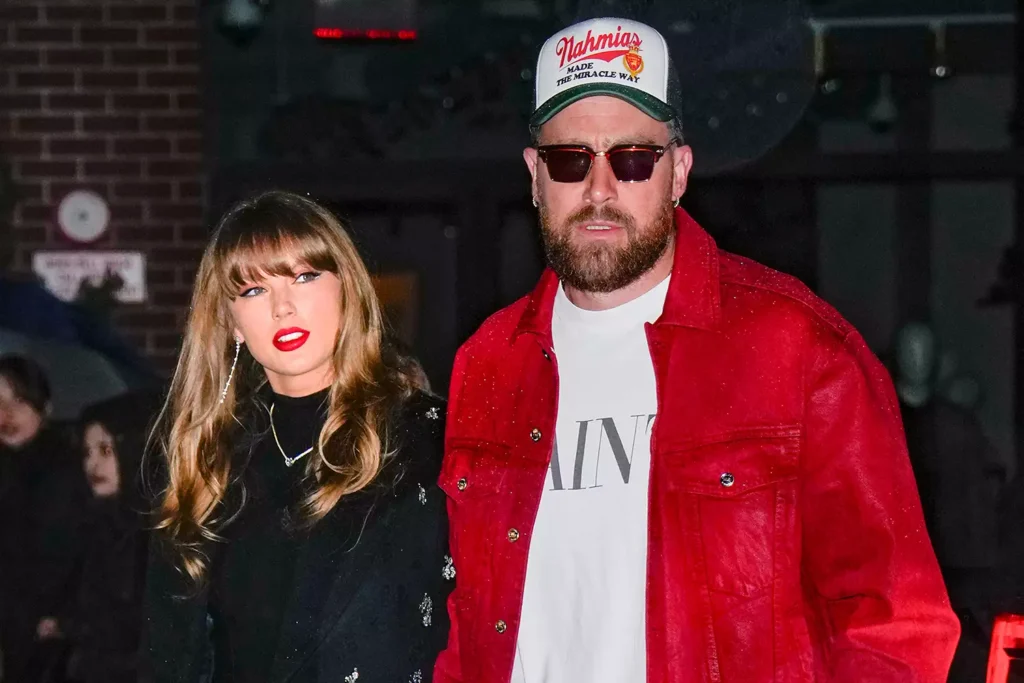 Taylor Swift in a black coat alongside Travis Kelce in a red jacket, showcasing the latest Travis and Taylor updates and street style.